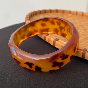 May include: A set of three ceramic mugs with a speckled, matte finish. The mugs are in shades of cream, light gray, and dark gray. Each mug has a simple, minimalist design and a rounded handle.