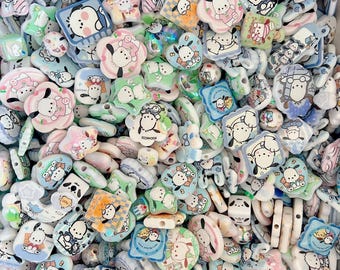 May include: A collection of colorful, cartoon-themed beads in various shapes, including stars, flowers, and squares. The beads feature a white dog character with black accents, set against pastel backgrounds of blue, pink, and green. These beads are ideal for jewelry making.