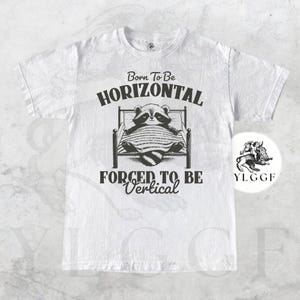 Born to Be Horizontal Raccoon Shirt | Funny Tired Lazy Animal Graphic Tee | Cozy Sleep Lover Gift | Introvert Humor Unisex T-Shirt