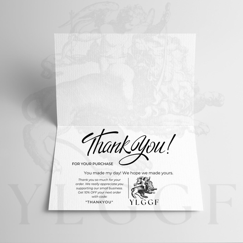 May include: A folded white card with the words "Thank You!" in elegant script. The card includes text expressing gratitude for a purchase and a discount code for future orders. A small illustration of a winged creature is also present.