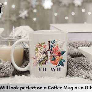 May include: White coffee mug with a floral design featuring a stylized anatomical illustration of lungs. The text "YH WH" is printed below the design.