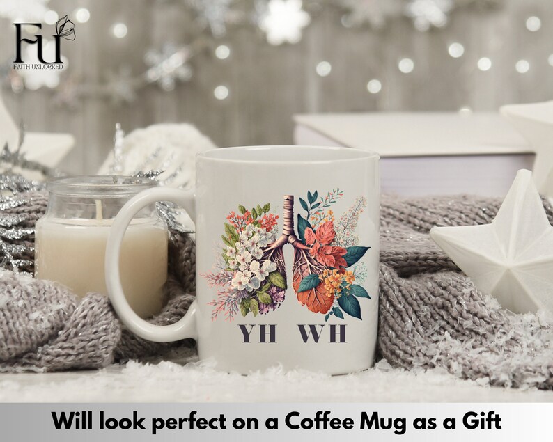 May include: White coffee mug with a floral design featuring a stylized anatomical illustration of lungs. The text "YH WH" is printed below the design.