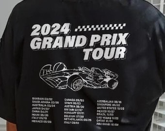 May include: Black t-shirt with a white graphic of a race car and the text "2024 Grand Prix Tour". The back of the shirt lists the dates and locations of the 2024 Grand Prix races.