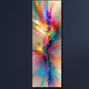 May include: Abstract art print featuring a vibrant explosion of colors. The artwork showcases a dynamic composition with splashes of orange, yellow, pink, blue, and green against a neutral background. The vertical canvas is displayed on a dark blue wall.