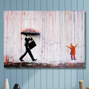 May include: A rectangular wall art print featuring a black silhouette of a person carrying a briefcase under a colorful umbrella, facing a small orange figure with arms raised. The background consists of vertical paint drips in various colors.