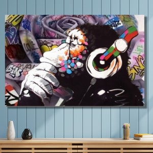 May include: A colorful graffiti-style painting of a monkey wearing headphones. The monkey is surrounded by colorful graffiti and text.