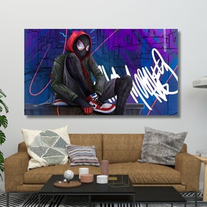 May include: A digital art print featuring a superhero in a black and red suit sitting on a ledge against a colourful graffiti background. The superhero is wearing a red hooded jacket and black mask. The background features a cityscape with purple, blue, and pink accents.