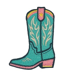 May include: An embroidered patch shaped like a cowboy boot in teal, featuring a pink pull tab with a yellow star, cream-colored flame-like stitching details, and a pink heel, all outlined with a dark navy blue border against a white background.