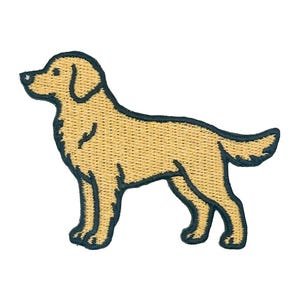 May include: An embroidered patch in the shape of a golden retriever dog standing in profile. The dog is light tan with a dark navy blue stitched border outlining its entire body, including the ears, legs, and tail, against a plain white background.