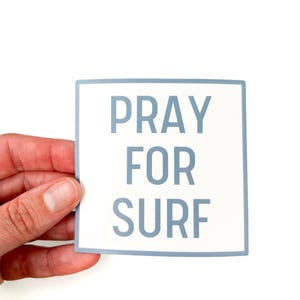 May include: A white sticker with a blue border and the text "Pray for Surf" in blue letters.