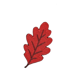 May include: A red oak leaf patch featuring dense embroidery with a dark brown stitched central vein and smaller branching veins. The leaf has a lobed, scalloped edge and a pointed tip, with a short stem extending from the bottom base.