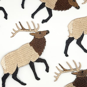 May include: Multiple embroidered patches featuring elk in a walking pose. Each elk has a tan body, a dark brown neck and head, and black legs. The antlers are light tan, and the patches are arranged in a repeating pattern across the frame.