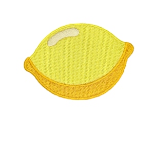 May include: Embroidered patch in the shape of a lemon. The lemon is primarily yellow with a white highlight and a golden-yellow border. The patch is likely for clothing or accessories.
