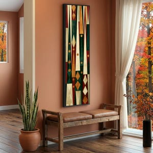 May include: A tall, rectangular wall art piece featuring a geometric pattern of elongated triangles, diamonds, and circles in shades of deep green, dark red, cream, and gold, enclosed within a thin black frame hanging on a wall.