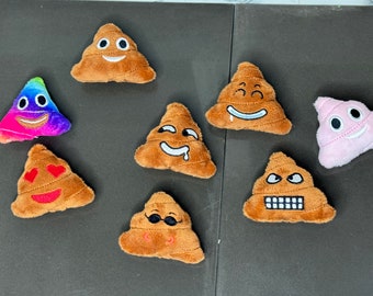 May include: Eight plush poop emoji toys with different facial expressions. The emojis are brown, pink, and rainbow colored.