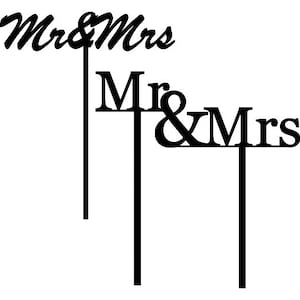 May include: Black and white cake topper with the text "Mr & Mrs" in cursive and "Mr & Mrs" in block letters.