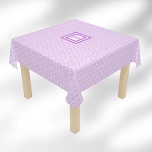 May include: A square lavender tablecloth with a repeating white pattern covers a small wooden table. The tablecloth has a diamond-shaped design in the center with the text "CRACK BOX SET". The table has four light-colored wooden legs.