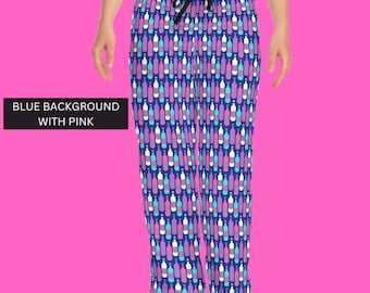 May include: Pajama pants with a repeating pattern of colorful bottles in shades of pink, purple, and blue on a navy blue background. The pants have a drawstring waist and are displayed against a bright pink background.