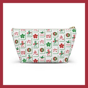 May include: White zippered pouch featuring a repeating pattern of Mahjong tiles in red, green, and black. The tiles include Chinese characters, flowers, and dragons. The pouch has a gold-colored zipper.