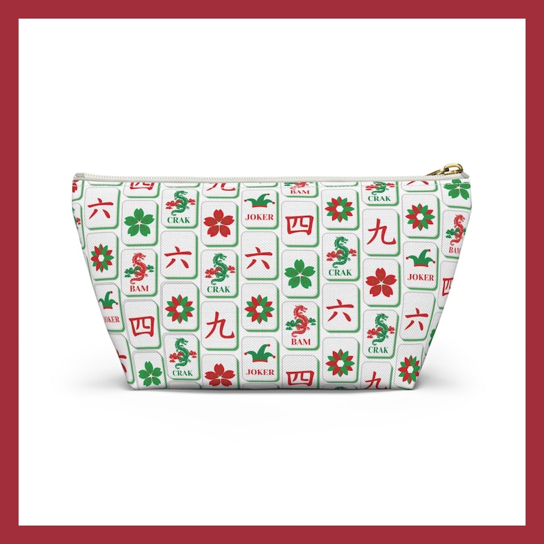 May include: White zippered pouch featuring a repeating pattern of Mahjong tiles in red, green, and black. The tiles include Chinese characters, flowers, and dragons. The pouch has a gold-colored zipper.
