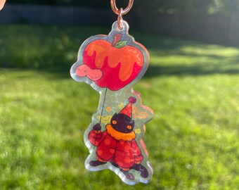 Black clown cat holding caramel apple balloon keychain