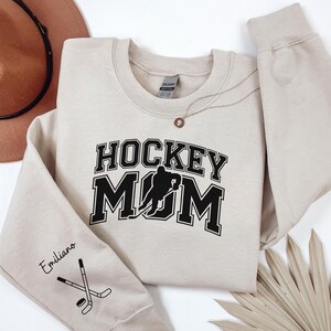 Personalized Hockey Mom Sweatshirt with kid name on sleeve, Custom Hockey Mom Hoodie, Hockey mom gift, Hockey Mama Sweater, Hockey Crewneck