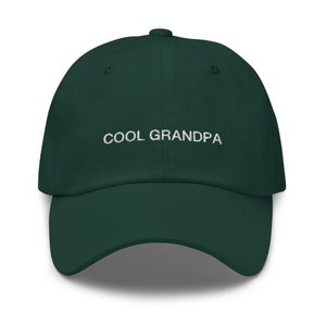 May include: A dark green baseball cap with the text "COOL GRANDPA" embroidered in white on the front.