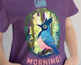 May include: Purple t-shirt with a cartoon blue jay in a green forest scene. The text "GOOD MORNING!" is printed on the shirt.