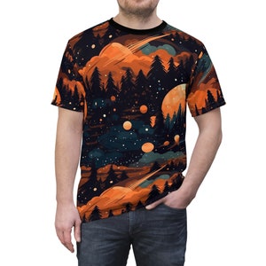 May include: A black t-shirt with a colorful print of a forest scene with orange clouds, stars, and planets. The print is a repeating pattern.