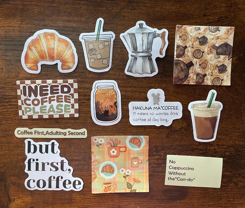 May include: A collection of coffee-themed stickers featuring a croissant, iced coffee, moka pot, and various text designs including I NEED COFFEE PLEASE, HAKUNA MA'COFFEE, Coffee First, Adulting Second, but first, coffee, and No Cappuccino Without the Can-do.