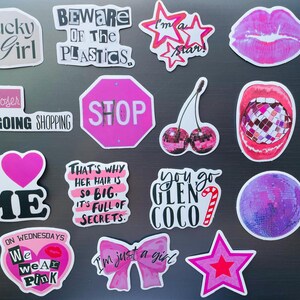 May include: A collection of colorful stickers with various designs and text. The stickers include phrases like "Lucky Girl," "I'm a star," and "We wear pink." Other designs feature lips, cherries, and a disco ball.