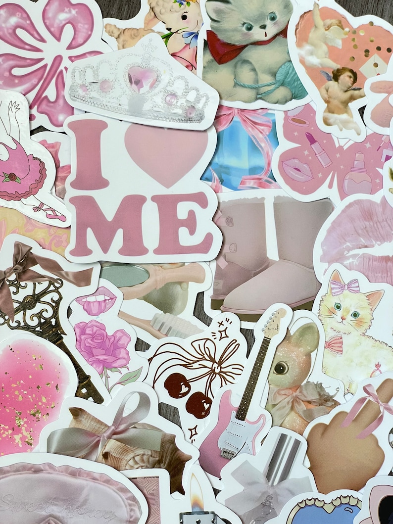 May include: A collection of pink and white stickers featuring various designs, including a crown, a heart with the text "I LOVE ME", a guitar, a cat, a flower, a pair of boots, and a cherub.