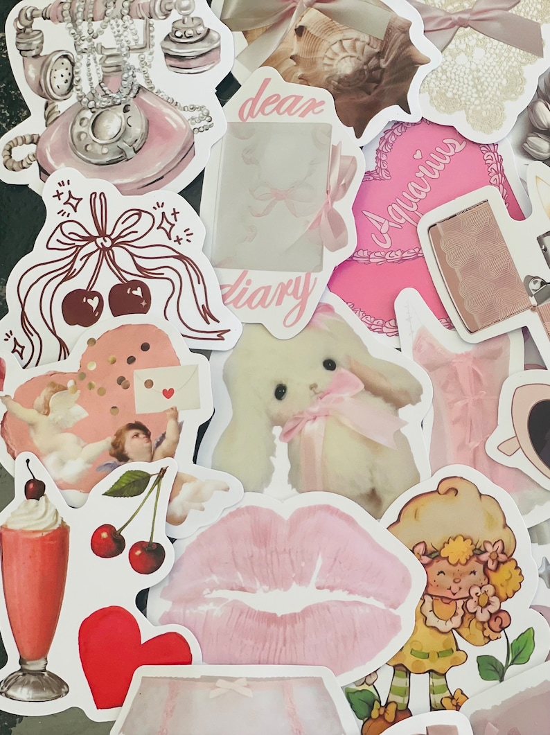 May include: A collection of pink and white stickers featuring various designs, including a vintage rotary phone, a heart with confetti, a cherub, a bunny, a pair of lips, a strawberry shortcake character, a seashell, a diary, a heart with the word "Aquarius", and a vintage lighter.