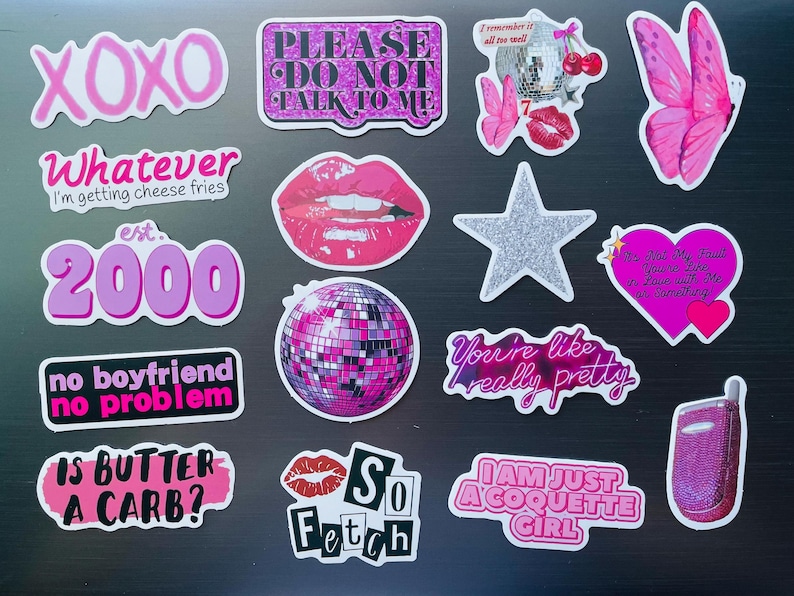 May include: A collection of pink and white stickers with various designs and text, including phrases like "XOXO," "Whatever," and "So Fetch." Other stickers feature a disco ball, lips, and a butterfly.