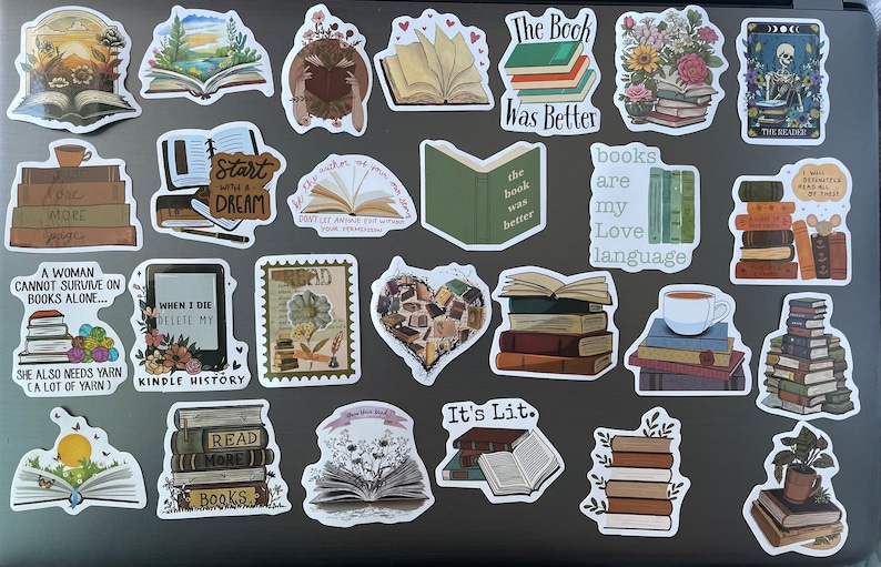 May include: A collection of book-themed stickers featuring various designs, including stacks of books, open books, and quotes about reading. The stickers are on a gray laptop.