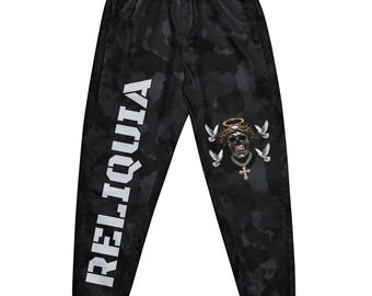 May include: Black camouflage joggers featuring the white text RELIQUIA printed vertically down the left leg. The right leg displays a graphic of a skull wearing a crown of thorns and a halo, surrounded by four white doves and a cross necklace.