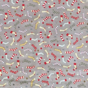 May include: A gray fabric with a repeating pattern of colorful socks. The socks are in various styles, including striped, polka dotted, and solid colors. The background is a light gray.