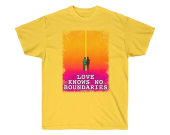 May include: Yellow t-shirt with a graphic of two people walking away from each other on a pink and orange background. The text "LOVE KNOWS NO BOUNDARIES" is printed below the graphic.