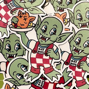 May include: A collection of stickers featuring a green goblin character in a red and white checkered outfit. The goblin is holding a plate with a cartoon animal on it. The stickers have the text "BAT BOY".