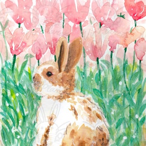 May include: A brown and white rabbit sits in a field of pink tulips. The rabbit is looking to the left of the image. The tulips are in bloom and the background is a soft pink.