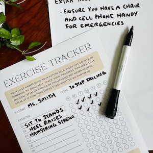 May include: An exercise tracker with the text "Exercise Tracker" and "Extra Instructions" is displayed. The tracker includes a list of exercises, a goal, and a space to mark daily progress. A black marker is next to the tracker.