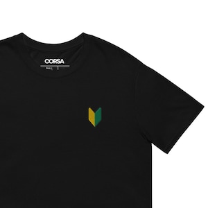 May include: Black t-shirt with a small green and yellow logo on the front. The logo is a stylized letter V.
