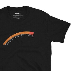 May include: Black short-sleeved t-shirt with a graphic of a red and orange speedometer with numbers 0 through 9.
