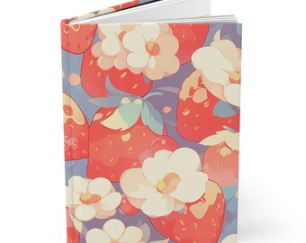 May include: A softcover journal with a colorful pattern of red strawberries and white flowers on a light purple background.