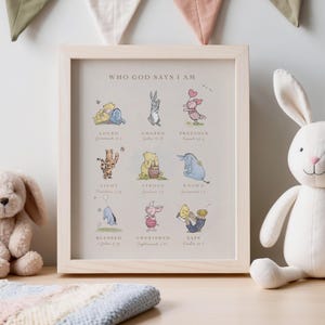 May include: A framed Winnie the Pooh-themed print with the title "Who God Says I Am". The print features various Winnie the Pooh characters with Bible verses underneath each character. The verses include: "Loved", "Chosen", "Precious", "Light", "Strong", "Known", "Blessed", "Cherished", and "Safe".