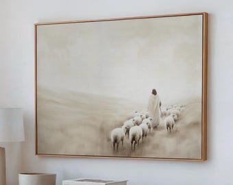 May include: A framed canvas art print depicts a figure in a white robe leading a flock of sheep across a misty landscape. The artwork is encased in a light brown wooden frame, creating a serene and pastoral scene.
