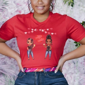 May include: Red t-shirt with a graphic of two cartoon women holding drinks and a banner that says "Happy Valentine's Day".