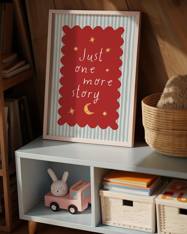 a framed poster with the text "Just one more story" on it, placed on a shelf next to a toy car and a basket.
