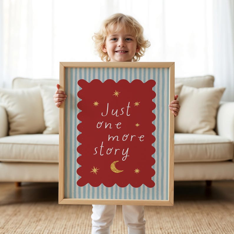 A young child holding a framed sign with the text "Just one more story" and stars on it.