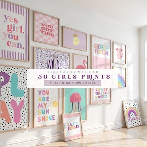 May include: A display of framed art prints in pastel shades, featuring phrases and illustrations. Prints include "Yes Girl, You Can", a sun, a rainbow, and a jellyfish. The text "50 Girls Prints" is also visible. The overall theme is playful and suitable for a girl's room.